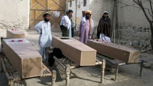 Residents stand near the coffins of victims of a missile attack in Mir Ali on the outskirts of Miranshah
