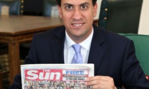 Ed Miliband holding his free copy of the Sun.